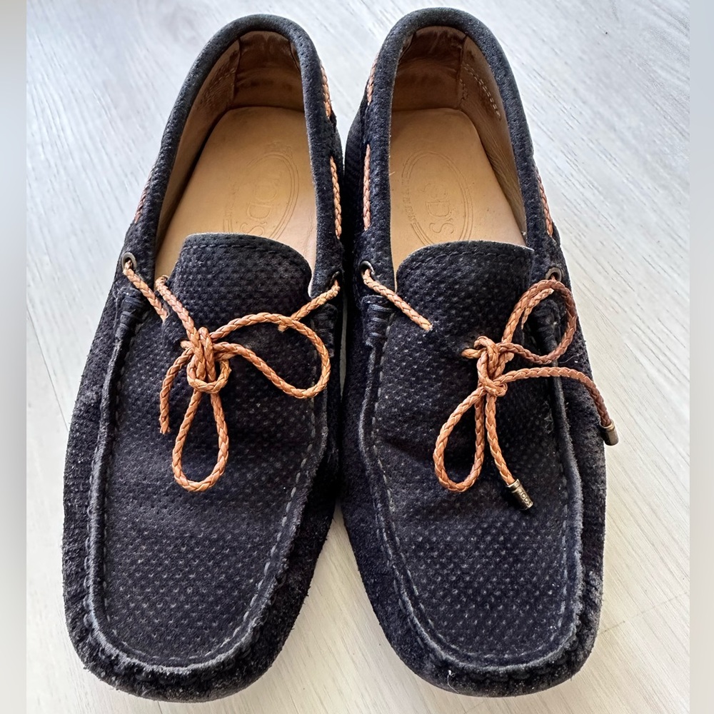 TOD’s navy suede loafers with brown braided leather lace.